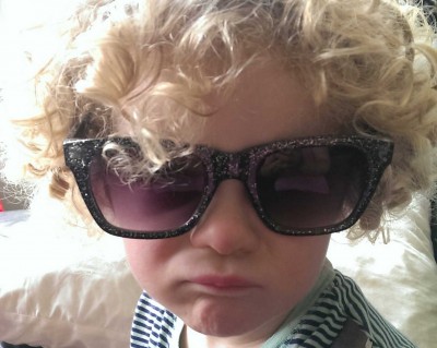 Child in sunglasses with a pout